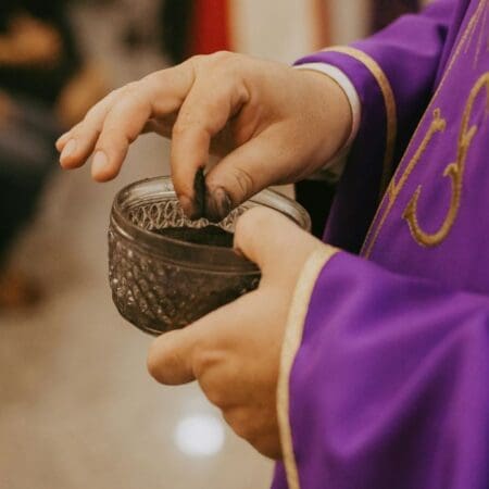 Priest with ash on Ash Wednesday